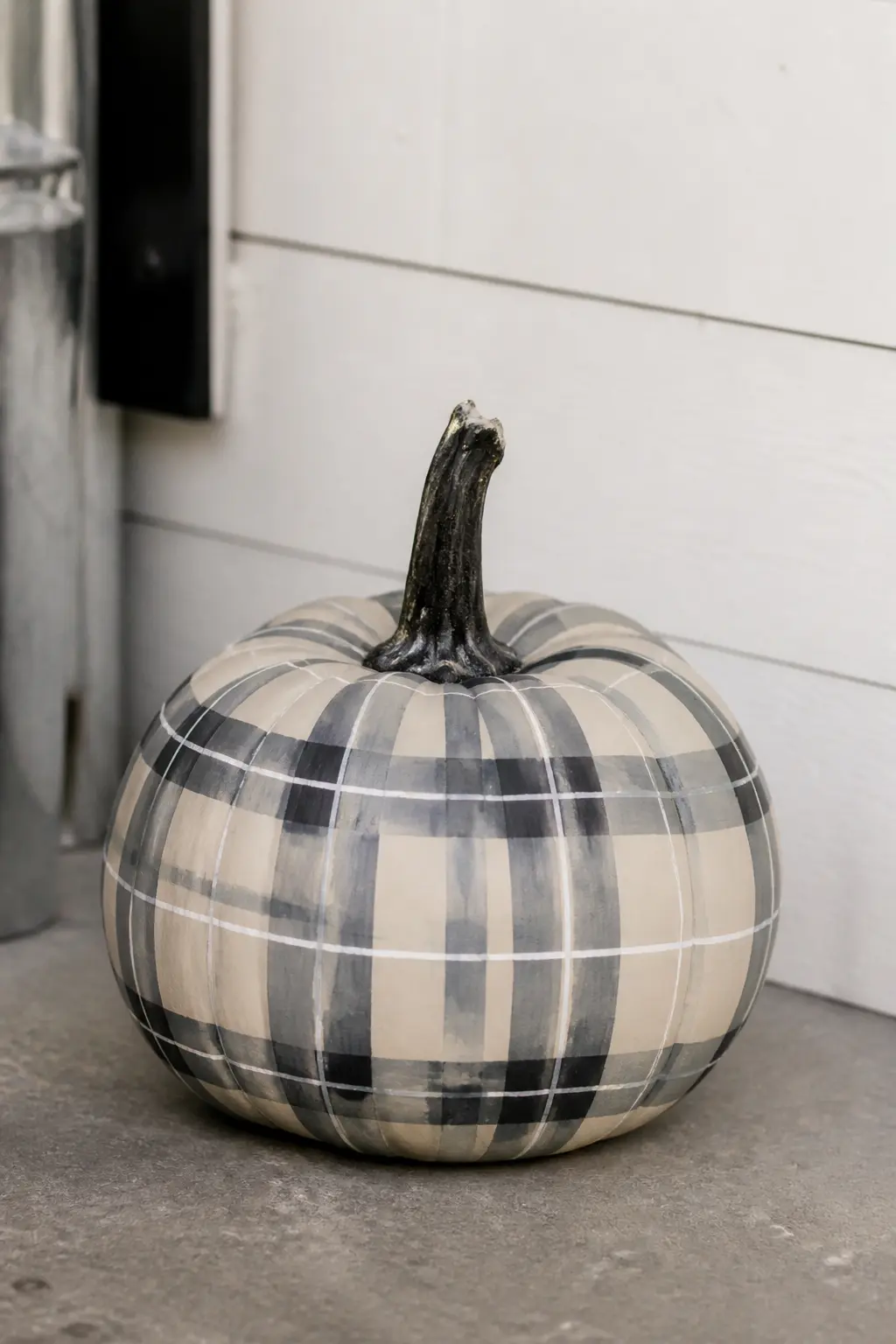 Grey and Charcoal Tartan With a White Line on a Cream Pumpkin — Grey and charcoal tartan is the most subdued pattern in this list. Plaid painted pumpkin
