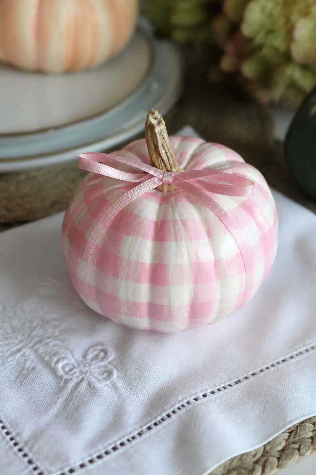 Pink and White Gingham With a Bow on a Painted Mini Pumpkin — Pink gingham on a white mini pumpkin with a narrow ribbon bow tied at the stem is the kind of