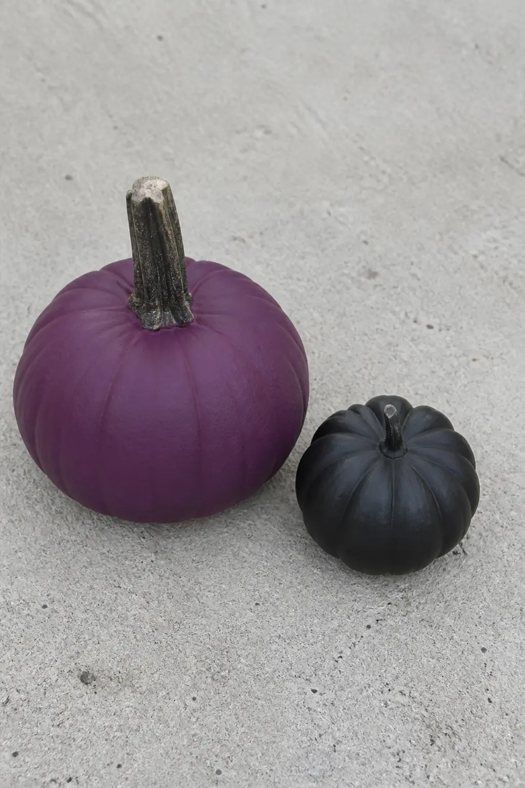 Aubergine Paired With a Black Pumpkin as a Set — Paint one pumpkin aubergine and one completely black, both with the same matte finish. Purple painted pumpkin