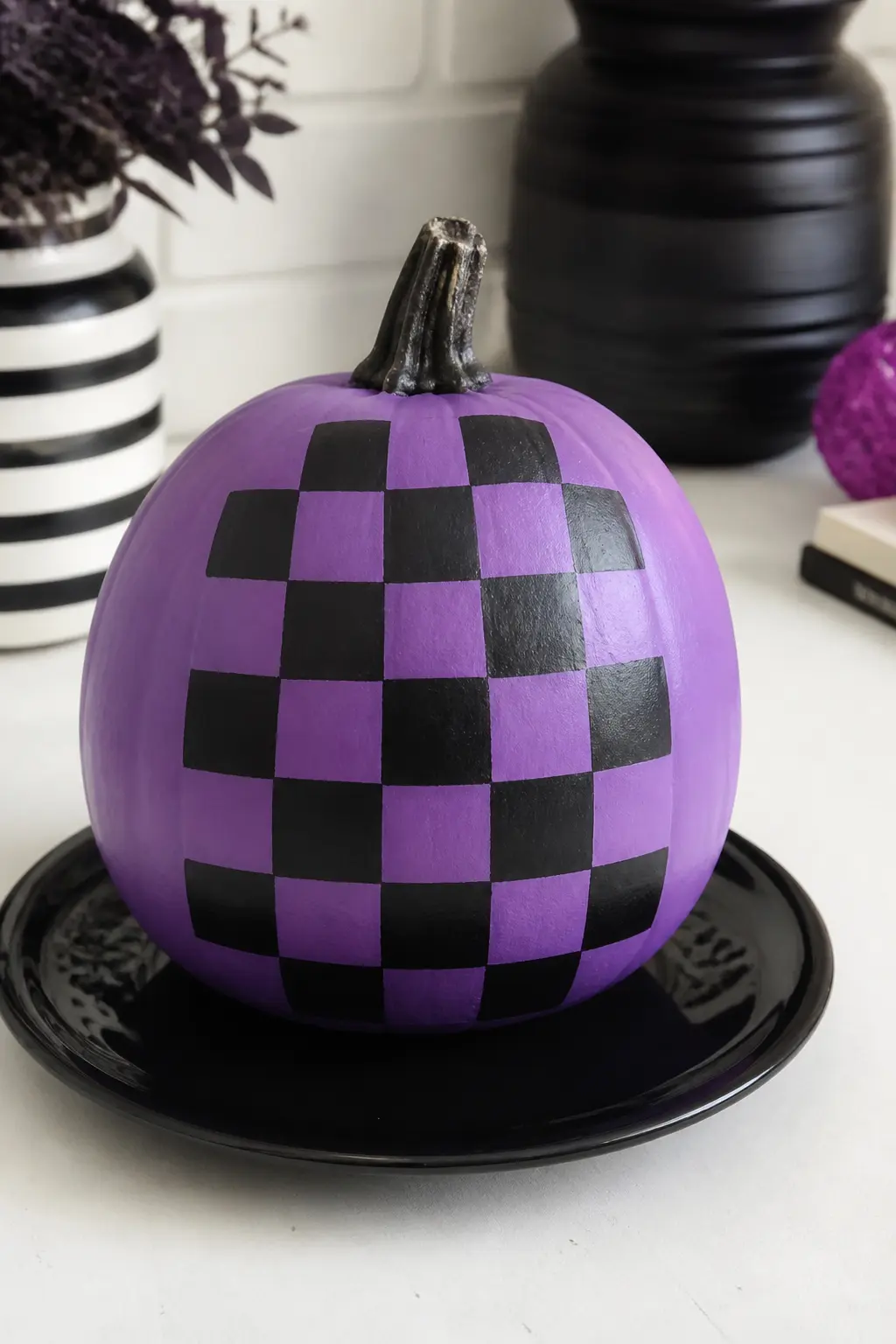 Mid Purple With a Checkerboard in Black — A checkerboard on a curved surface sounds technically difficult. Purple painted pumpkin