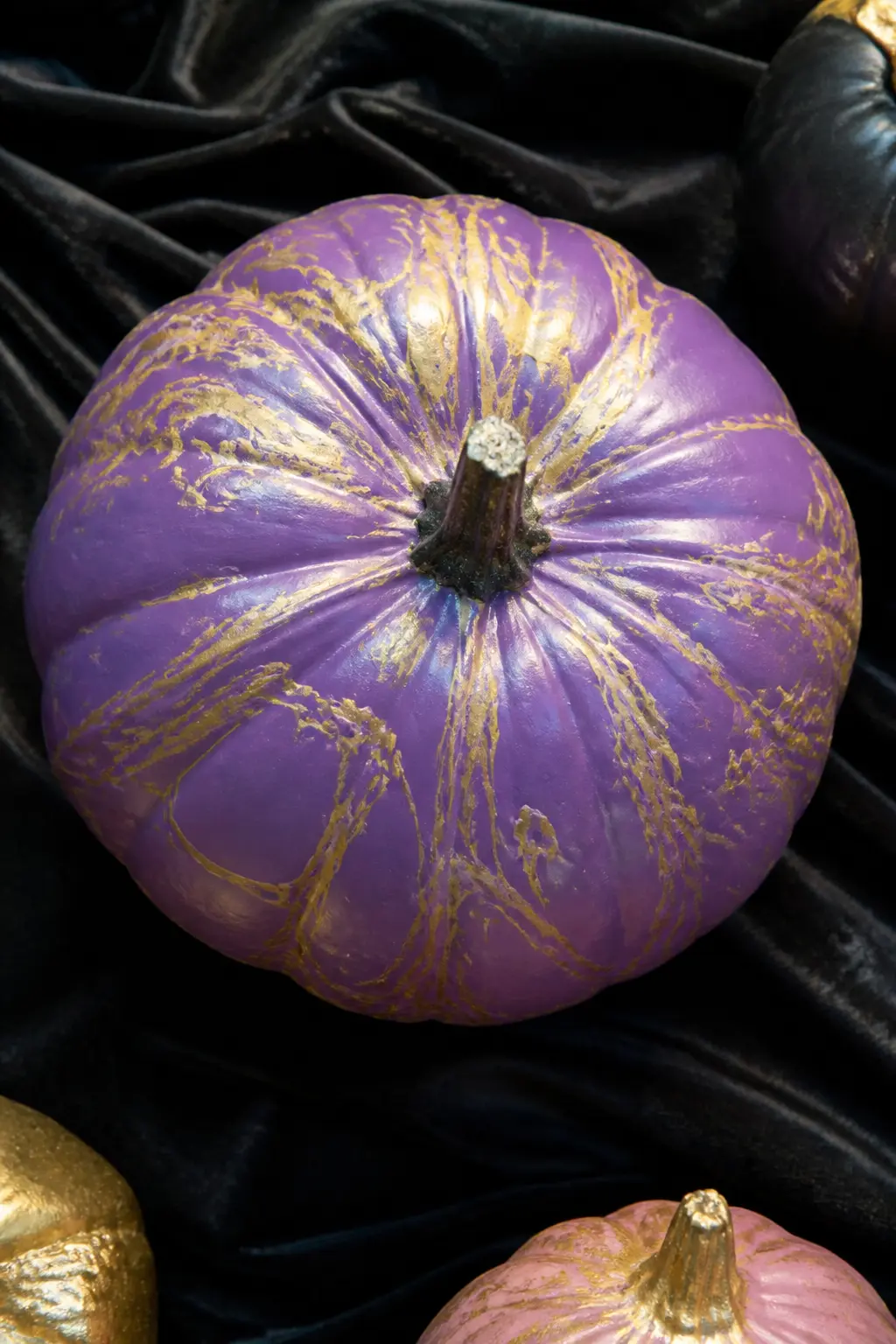 Mid Purple With Gold Marbling Poured Over — Pour marbling uses a watered-down metallic paint drizzled from a spoon or squeeze bottle, then tilted on the