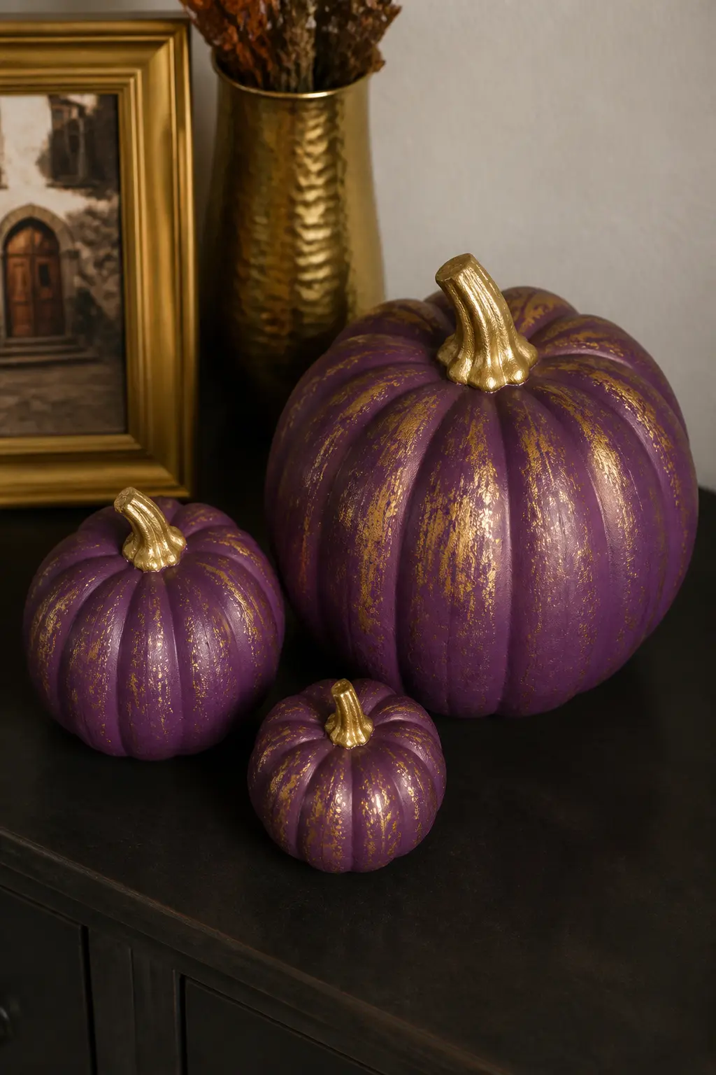 Purple and Gold Only, in Three Sizes — Three pumpkins: small, medium and large. Purple painted pumpkin
