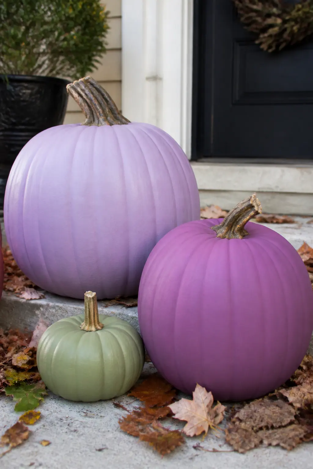 Purple With One Green Pumpkin to Lift It — Paint three or four pumpkins in purple shades, any shades from this article, and add one pumpkin painted in a muted