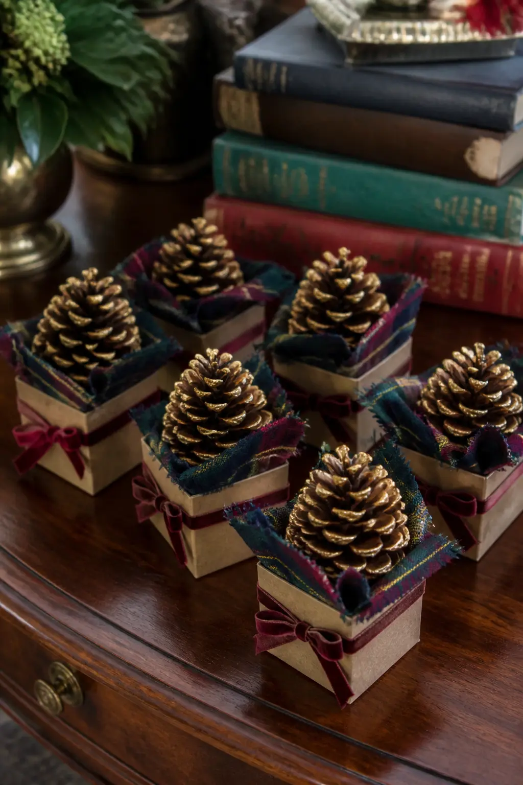 The Gold-Dipped Pine Cone Party Favour — Dip the tip of a large pine cone in gold paint, let it dry fully, then stand it in a small kraft box lined with a