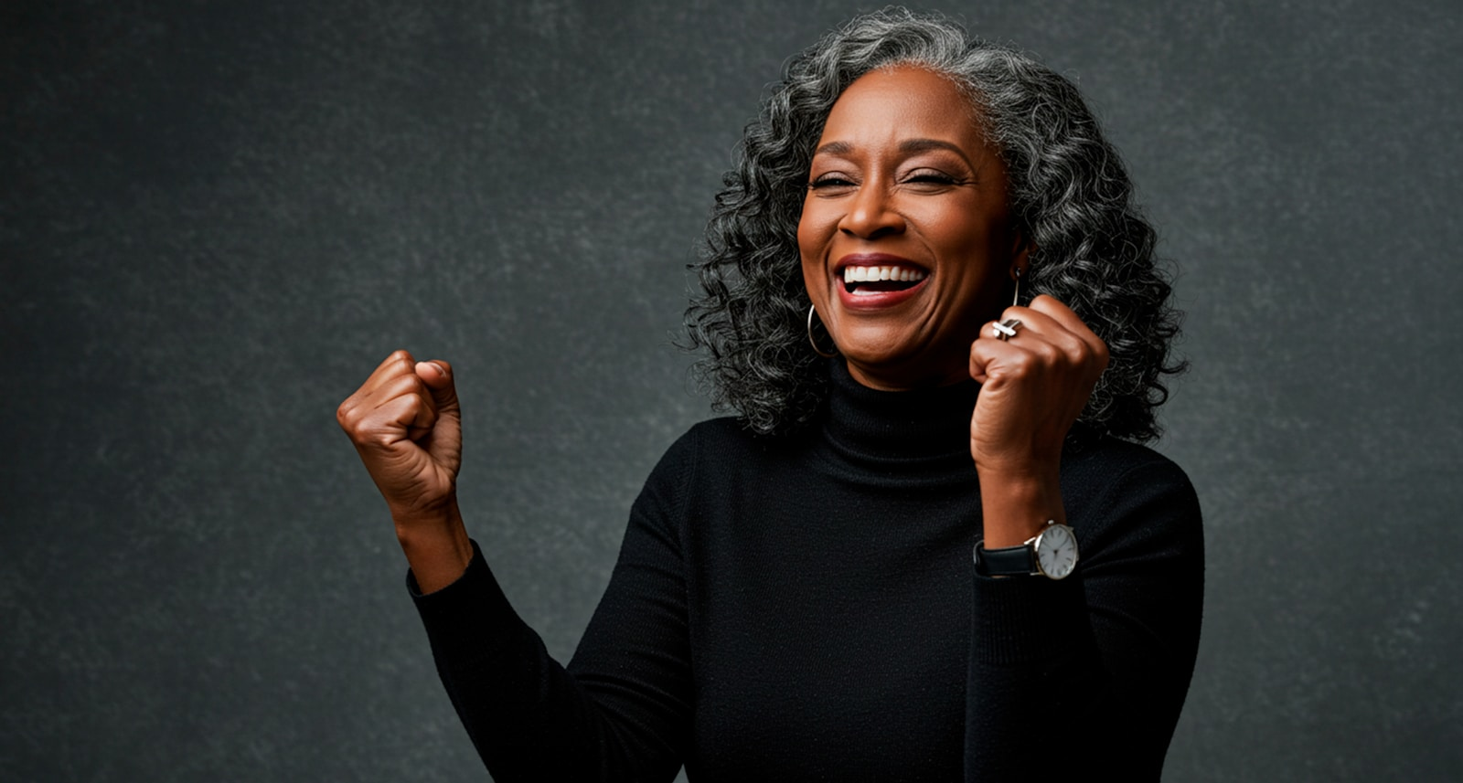 Smiling woman with gray hair celebrates her success