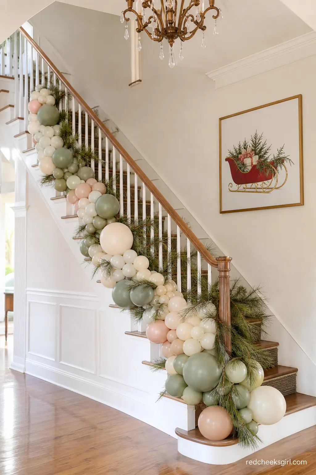 Sage and Cream Organic Garland along the Staircase — An organic balloon garland in sage green, cream and blush runs the full length of a staircase railing
