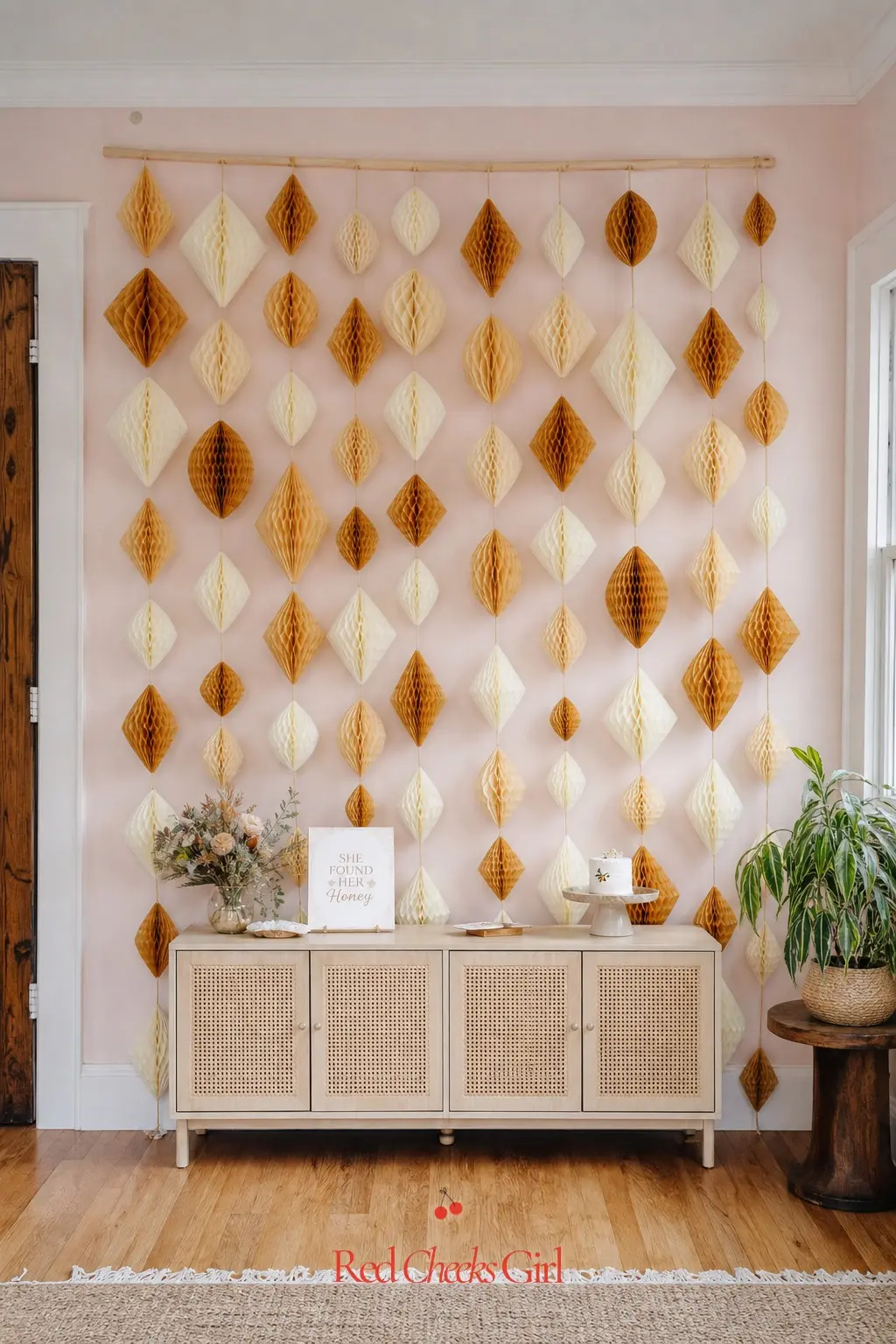 Hanging Paper Honeycomb Backdrop — A flat wall behind the gift chair or the cake table needs almost nothing to become a backdrop, just height and repetition.