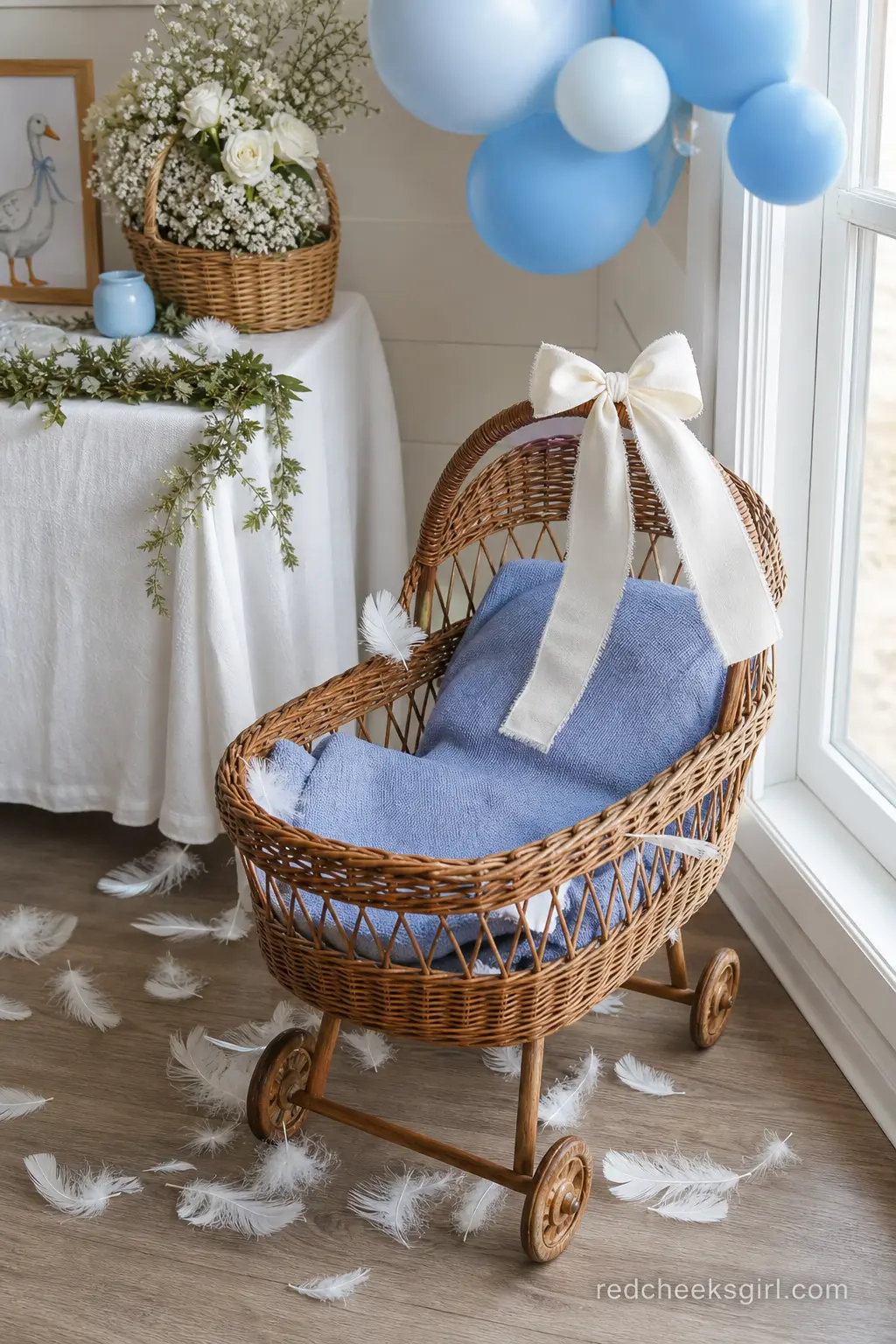Feather and Wicker Photo Nook — A quiet corner holds a vintage wicker bassinet lined with a periwinkle blue blanket, a scattering of soft white feathers around