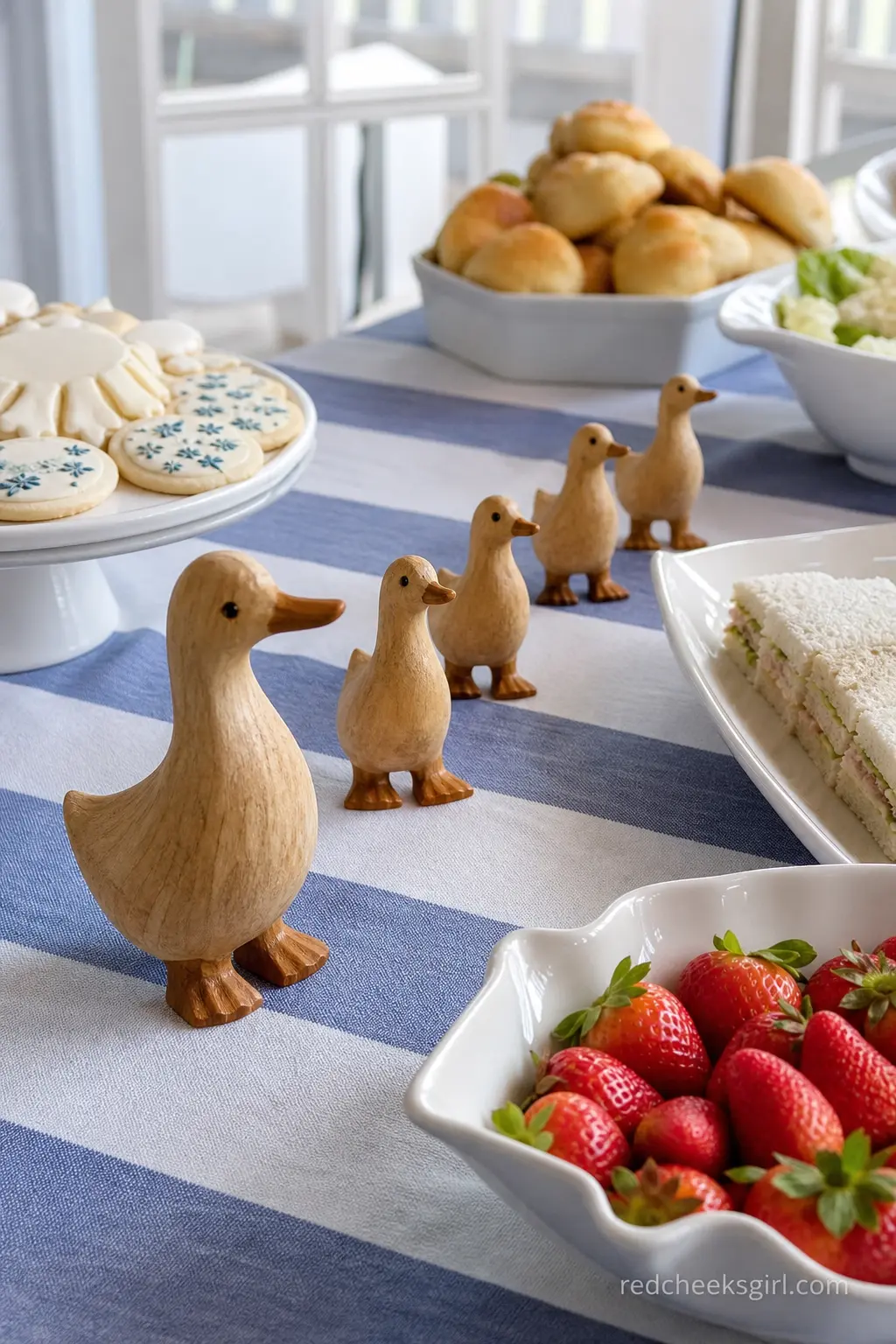 Wooden Goose Centerpiece Trail — A line of small hand-carved wooden geese marches down the center of the food table, adding height between platters without a