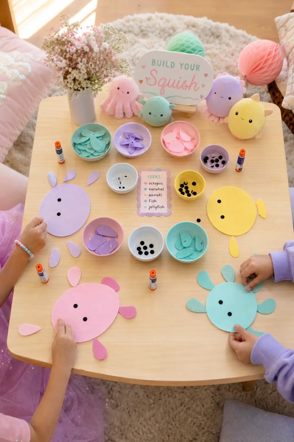 Build-a-Character Craft Table — Set out pre-cut felt ovals in five pastel colours, along with pre-cut felt dots for eyes, small felt horns, ears and fins, and