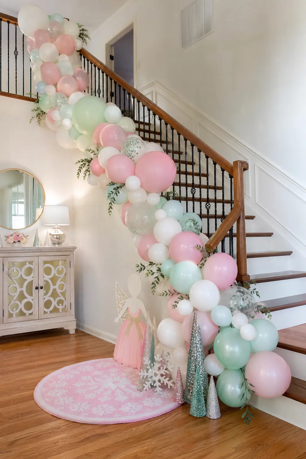 Organic Balloon Garland Staircase Swag — An organic balloon garland in blush, mint and ivory swags along a staircase railing from the top step to the bottom