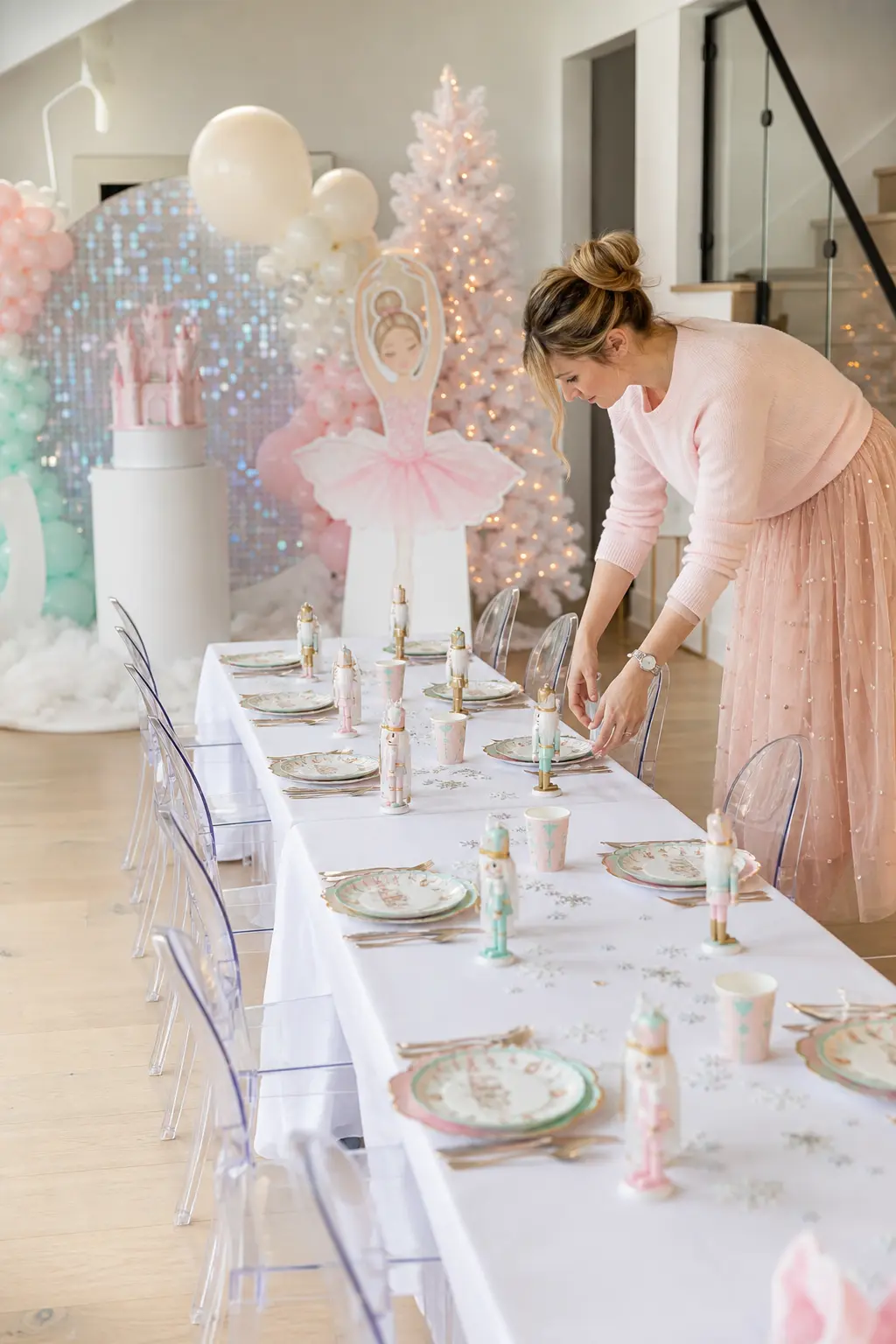 Snowflake Kids Table — A long low table for the youngest guests, dressed in plain white linen, gets scattered with silver snowflake confetti and small wooden