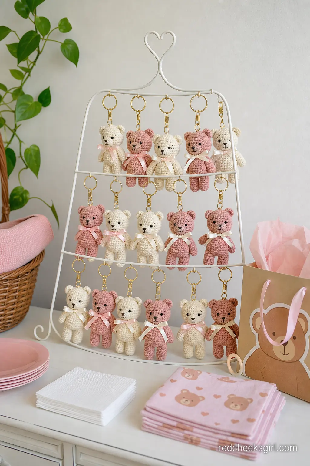 Crocheted Bear Keychain Display — A small pegboard or wire stand hung with cream and dusty rose crocheted bear keychains gives guests a favor with real