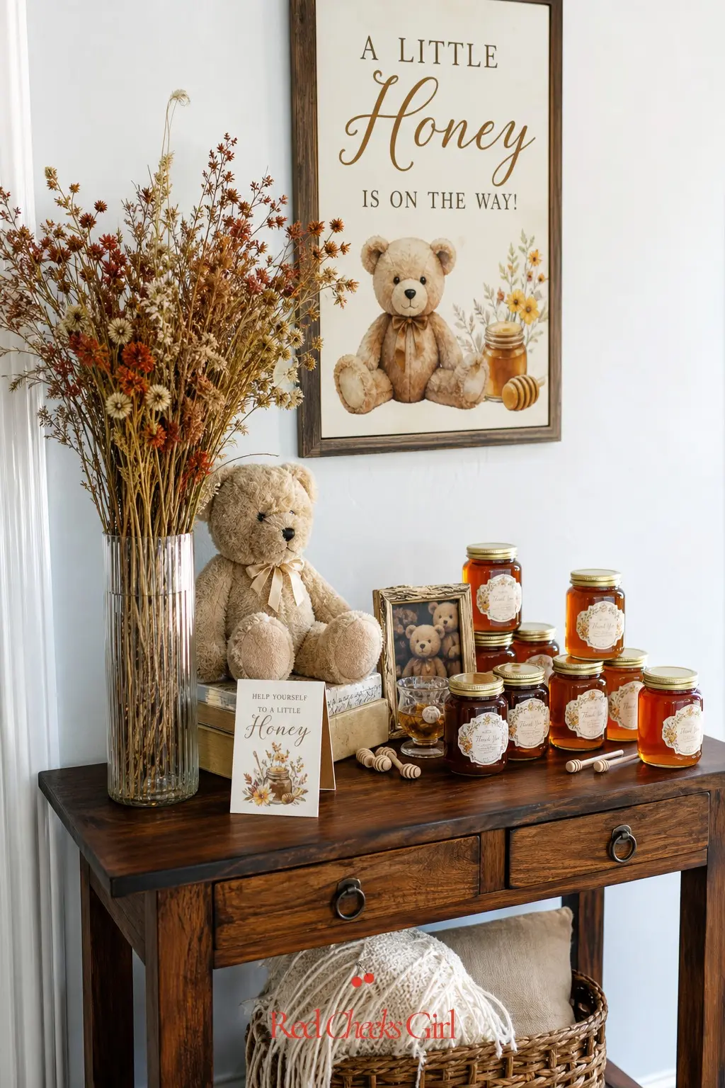 Honey And Wildflower Entrance Table — A narrow console table just inside the front door, set with amber honey jars and a loose bundle of dried rust colored