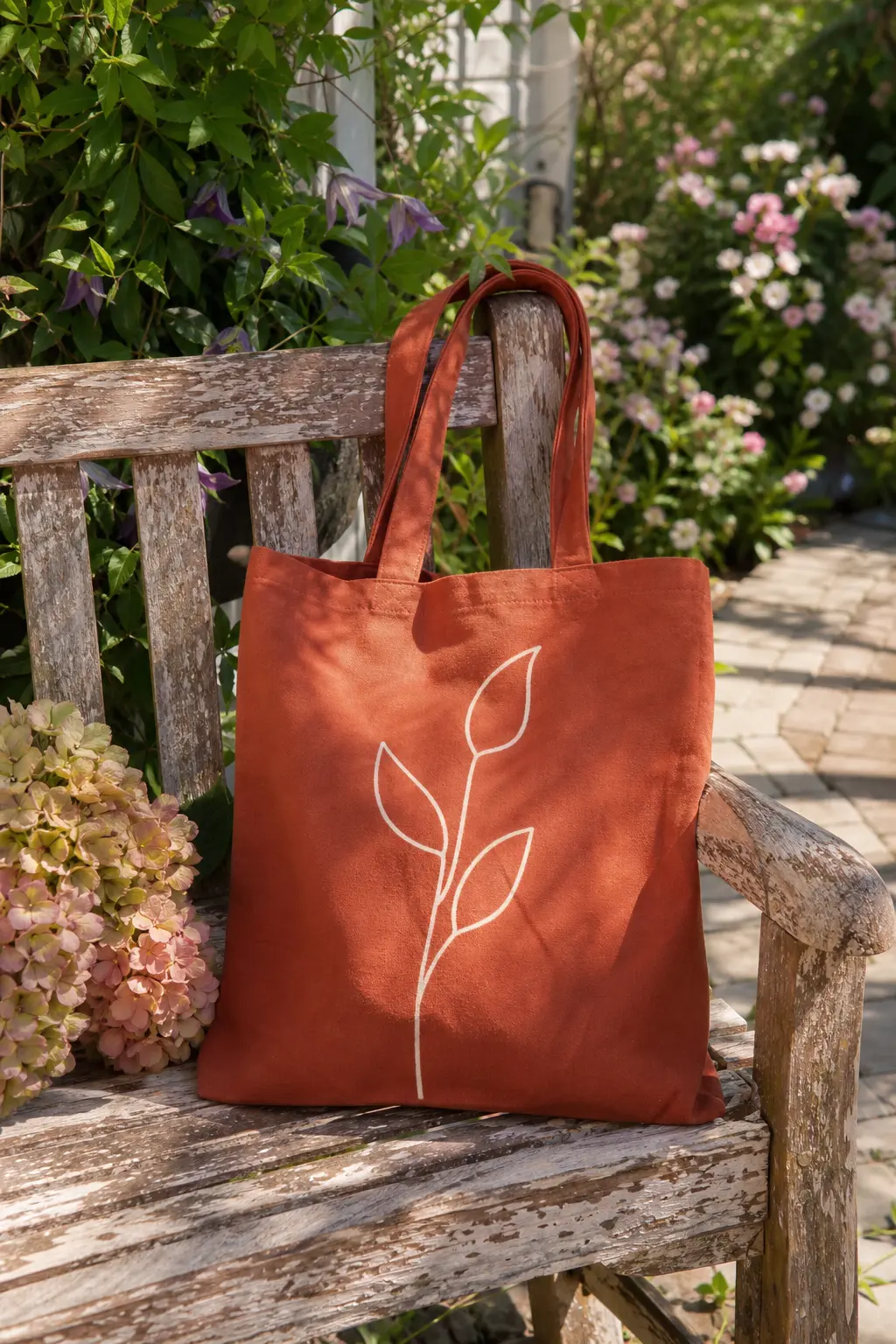 Single Stem Line Drawing Tote — One continuous cream line, drawn with a fabric paint pen rather than a brush, traces a single tall stem with three simple