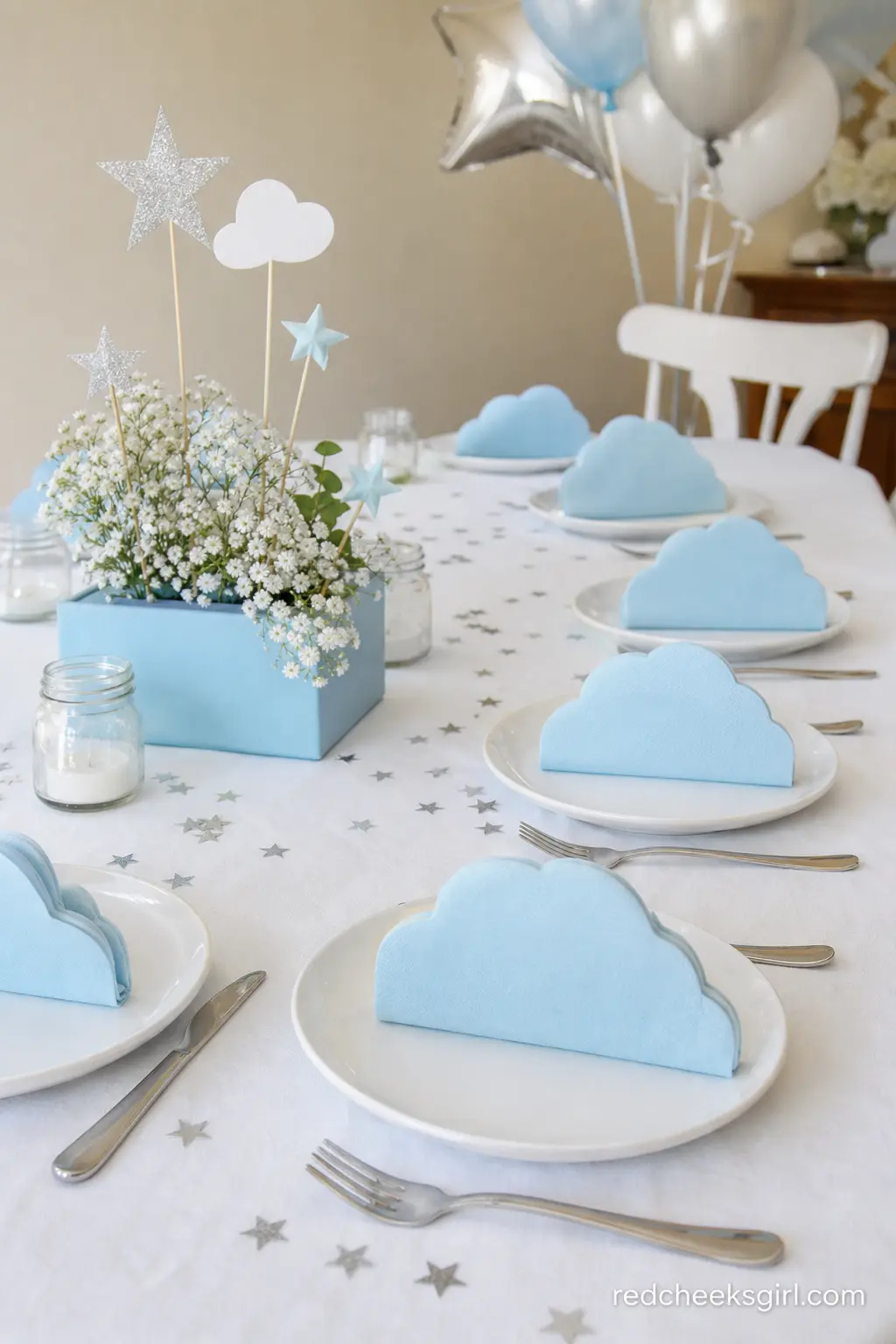 Cloud Napkin Fold Table — Powder blue napkins folded into soft cloud shapes with a scatter of silver star confetti bring the sky theme down to the plate