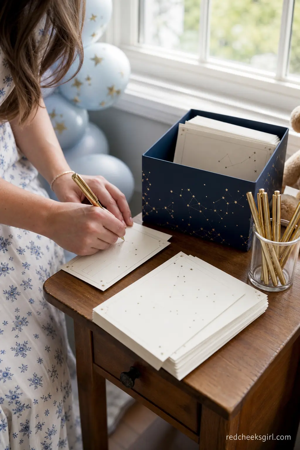 Constellation Wish Card Station — Cream cards printed with faint constellations, a navy collection box and a cup of gold pens give guests a quiet activity