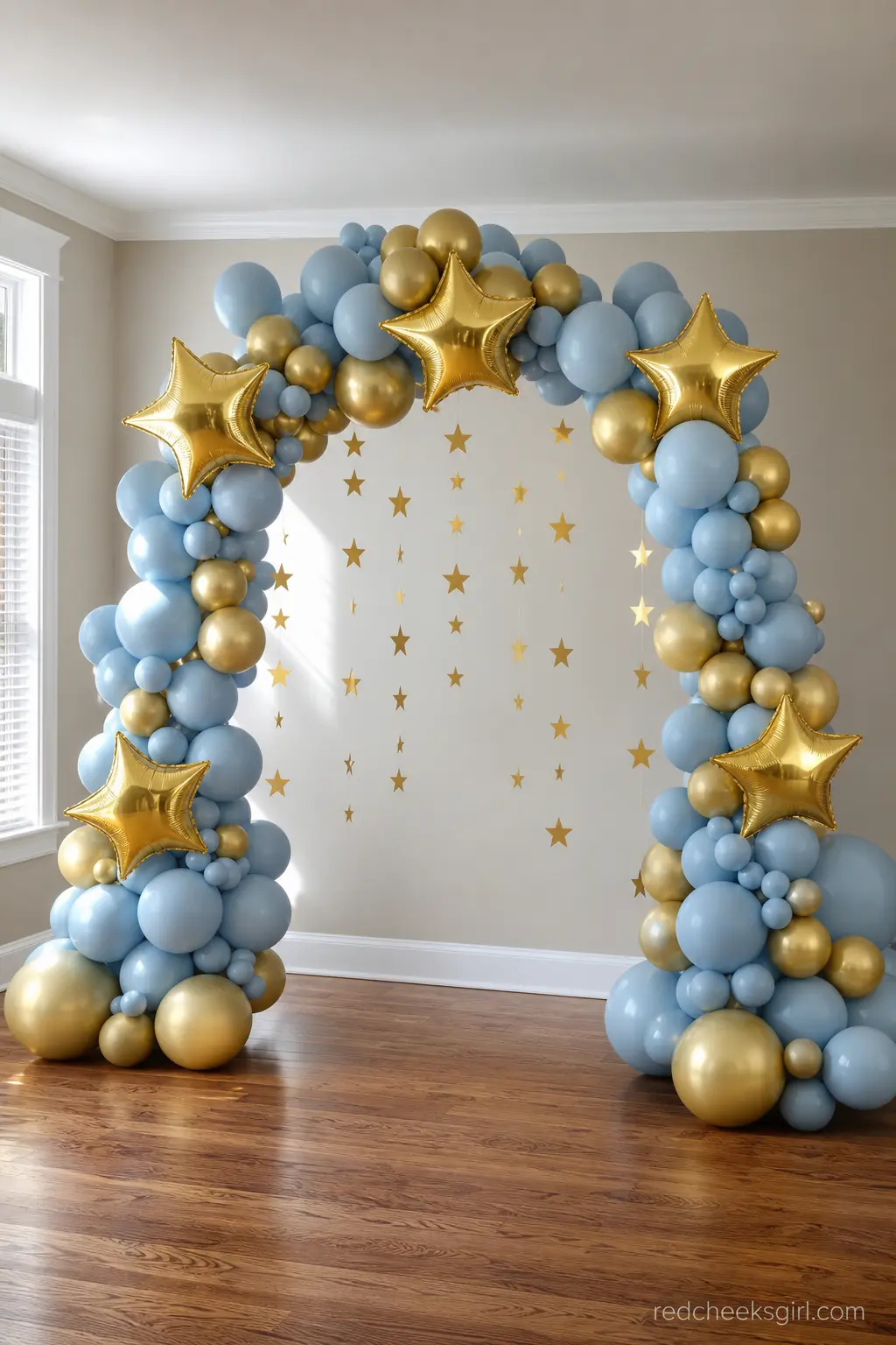 Gold Star Balloon Arch — A dusty blue and gold balloon arch is the one decoration guests notice from across the room. Twinkle little star baby shower ideas