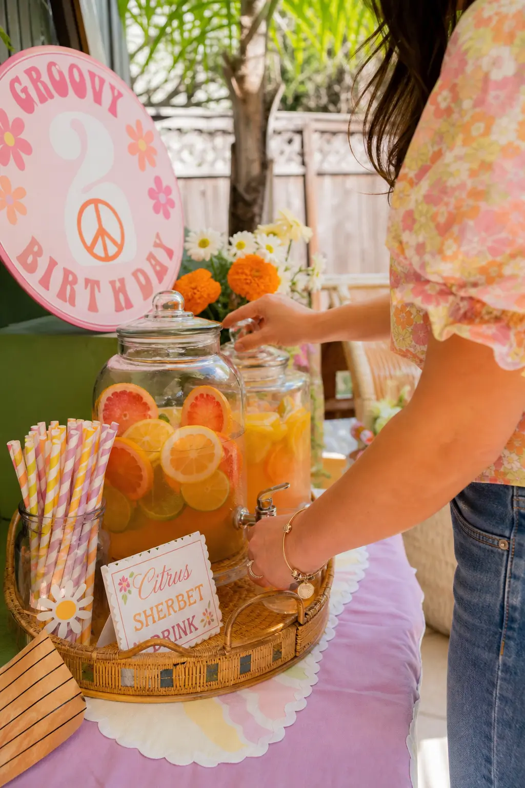 Citrus Sherbet Drink Station — Glass beverage dispensers filled with citrus slices and lavender or marigold striped paper straws turn drinks into their own