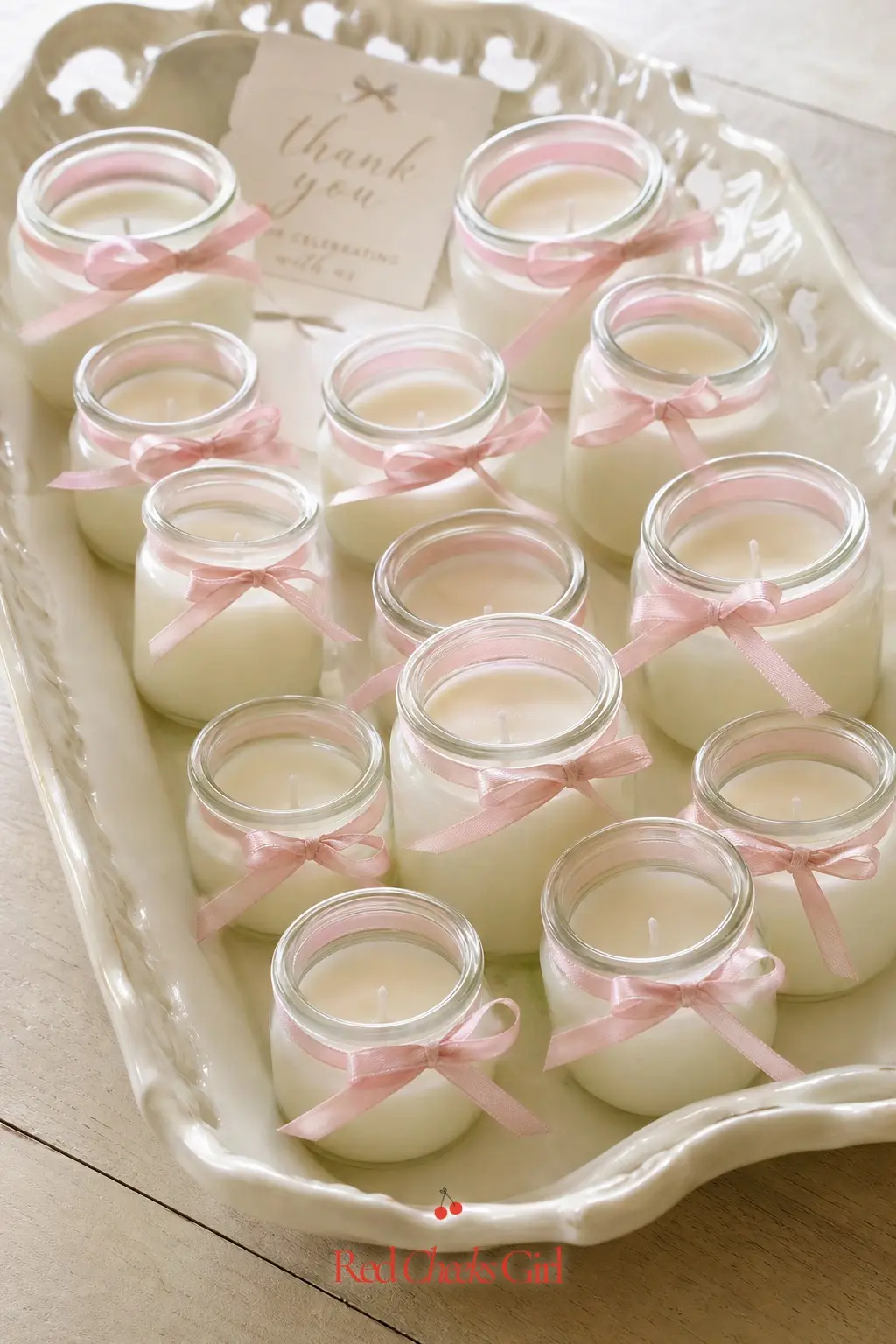Bow-Topped Mini Candle Favors — Small glass candles, each with a thin bow tied around the neck, give guests something to actually burn at home rather than