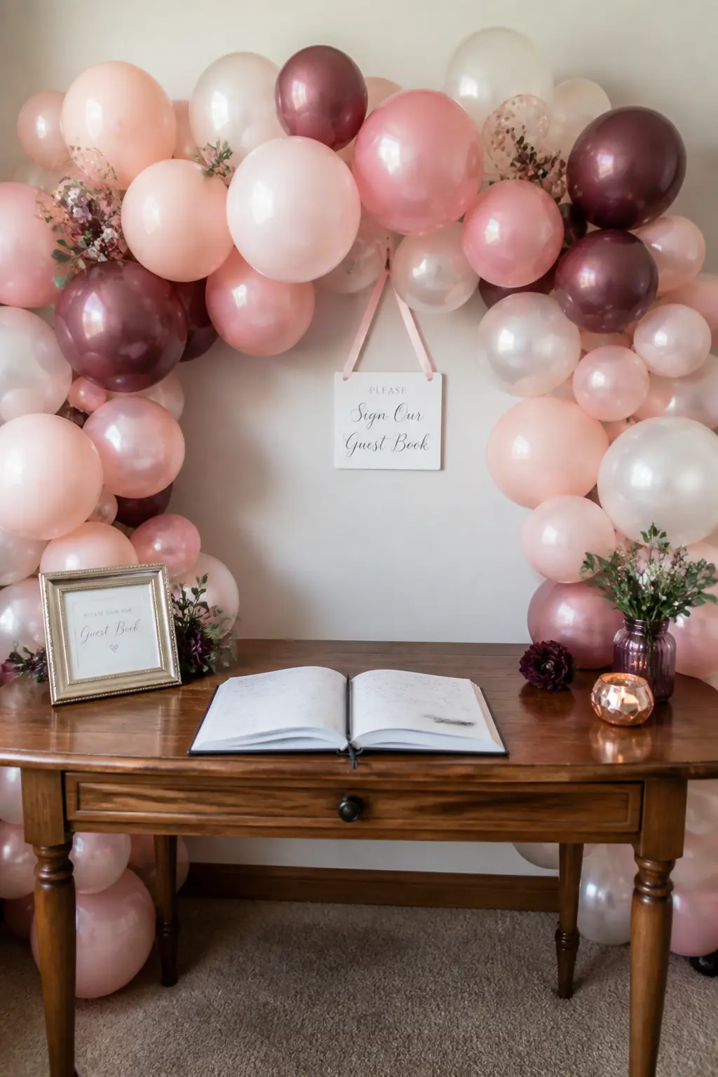 Blush, Mauve and Pearl Behind the Guest Book Table — A garland in blush, mauve and pearl fills the wall directly behind the guest book table. Wedding balloon
