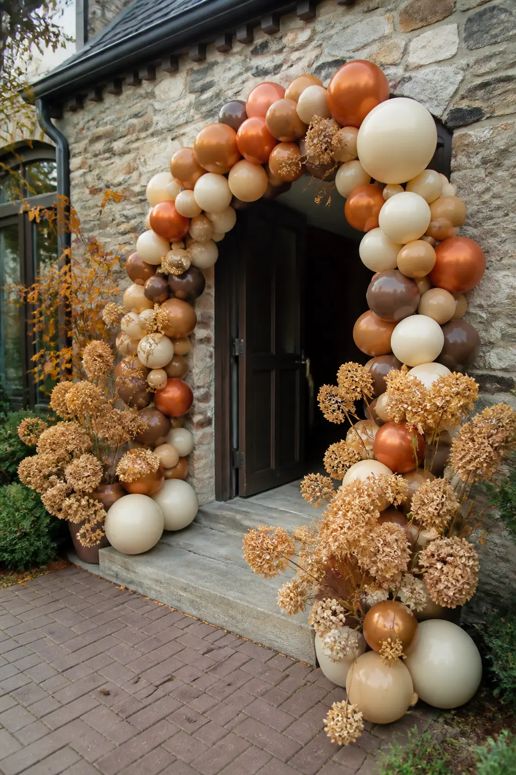 Rust, Cream and Copper at an Autumn Wedding Entrance — A rust, cream and copper arch stands at the entrance of an autumn wedding venue. Wedding balloon arch