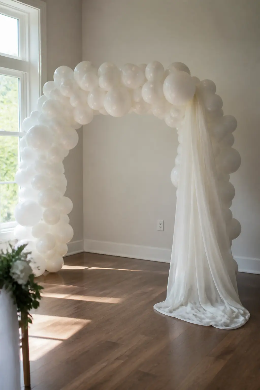 White Garland with a Fabric Drape Falling from One Side over a Ceremony Spot — A length of sheer fabric draped from one side of a ceremony arch, falling to the
