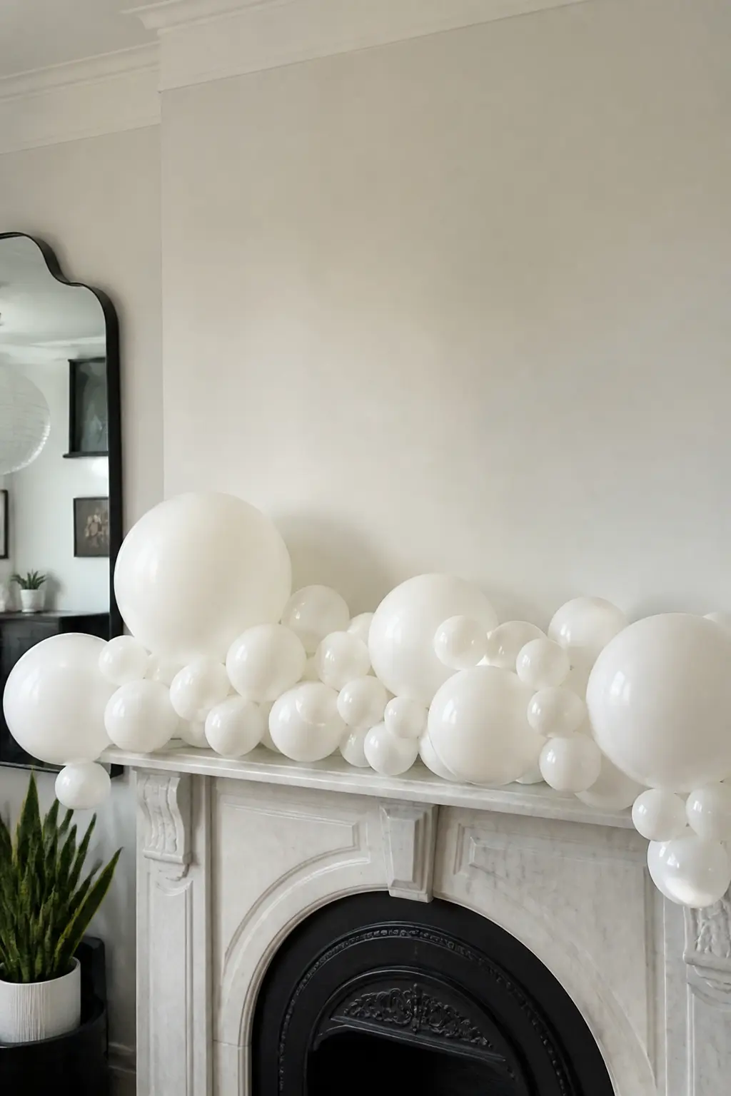 White Garland in Four Sizes in Irregular Clusters Along a Mantel — The mantel is the one surface in a room with a natural focal point on either side and a