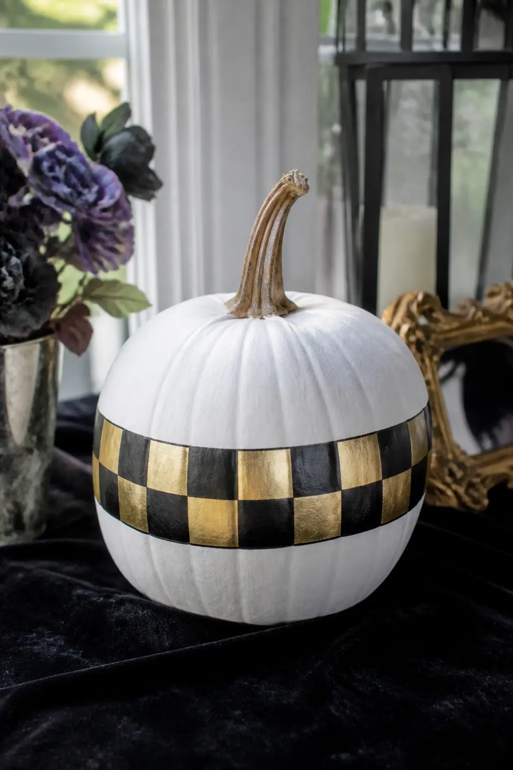 Black and Gold Checkerboard Band — A band of checkerboard squares runs around the widest part of the pumpkin, alternating black and gold squares in equal