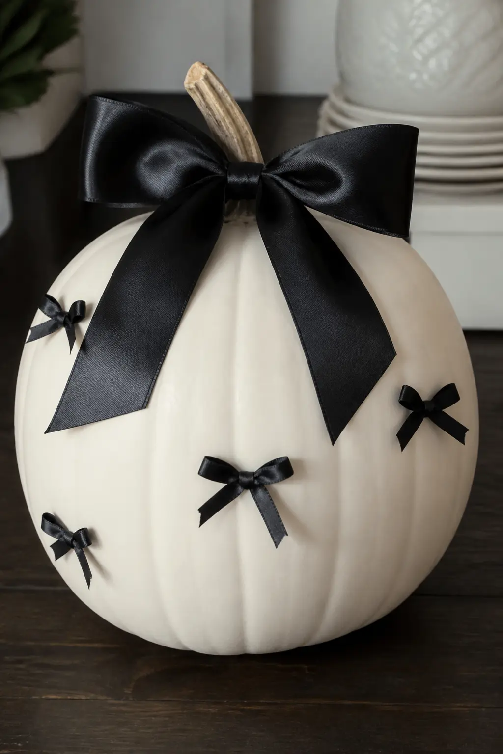 Black Satin Bow With Scattered Mini Bows — A large black satin bow wired around the stem is the centrepiece, and a handful of smaller pre-made bows glued at