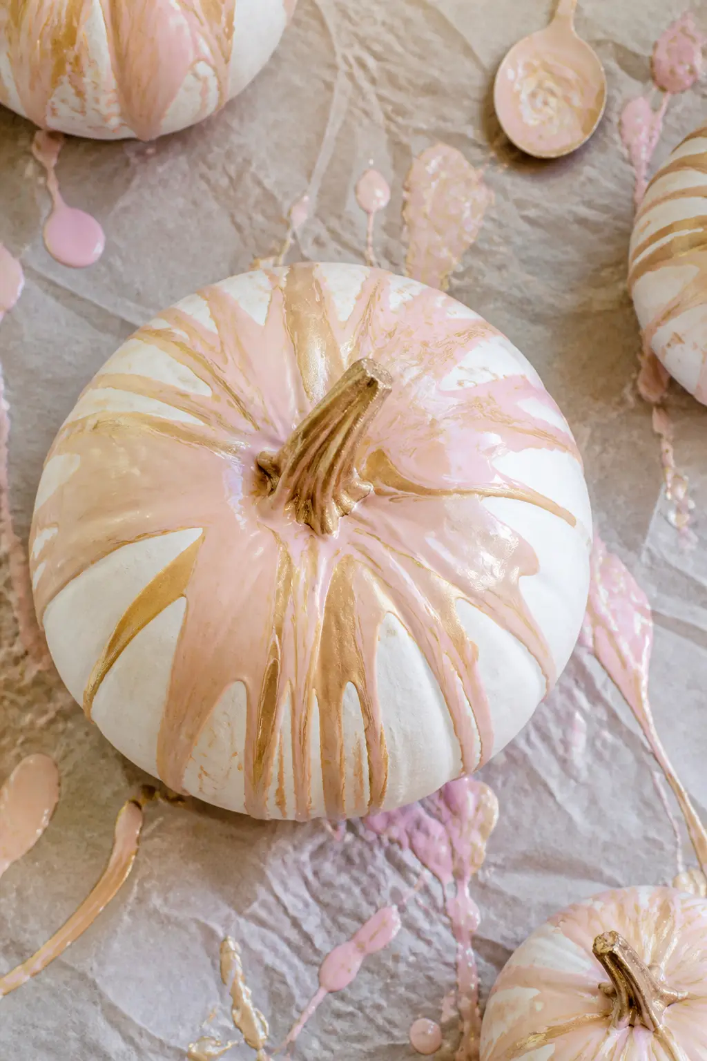 Blush and Gold Marbled Top — Diluted blush pink and gold metallic paint are poured together over the crown of the pumpkin and allowed to run down the ridges in