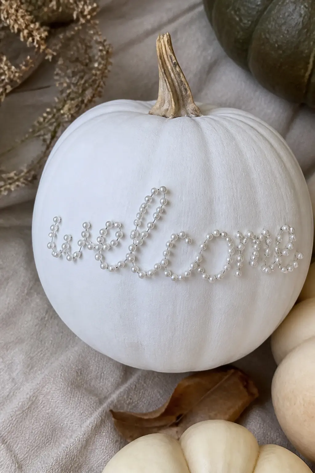 Pearl Pin Lettering — Pearl-headed dressmaker pins pushed into a faux pumpkin spell out a word, a name or a short phrase. White painted pumpkin
