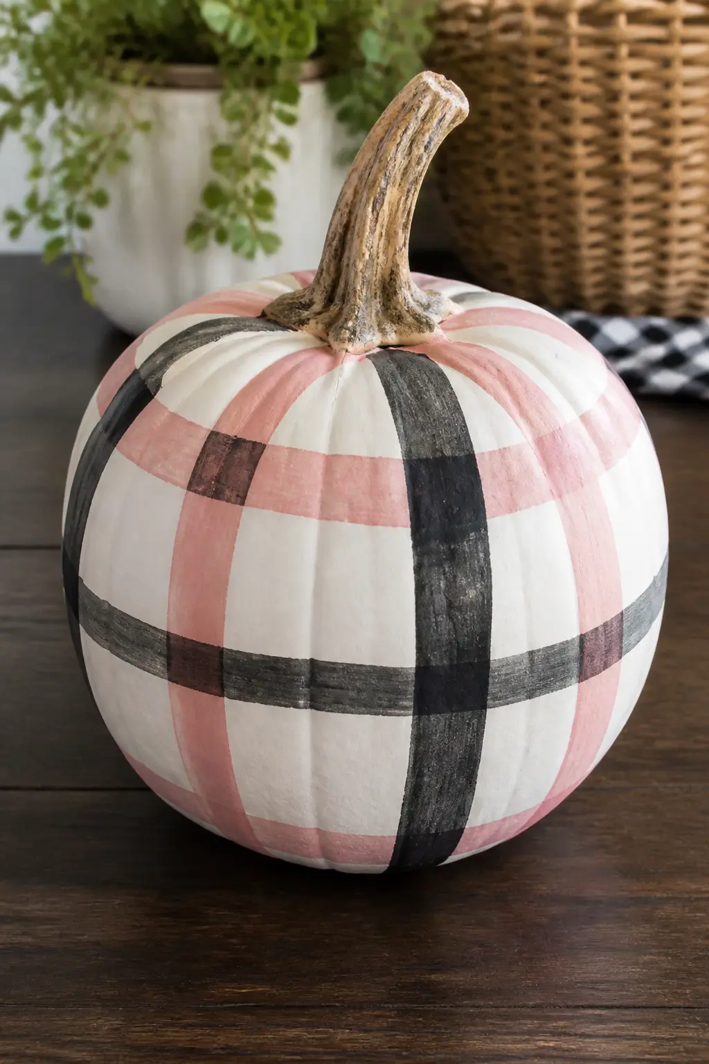 Pink and Black Plaid Grid — A pink and black plaid grid covers the pumpkin body, created by masking horizontal and vertical stripes with painter's tape and
