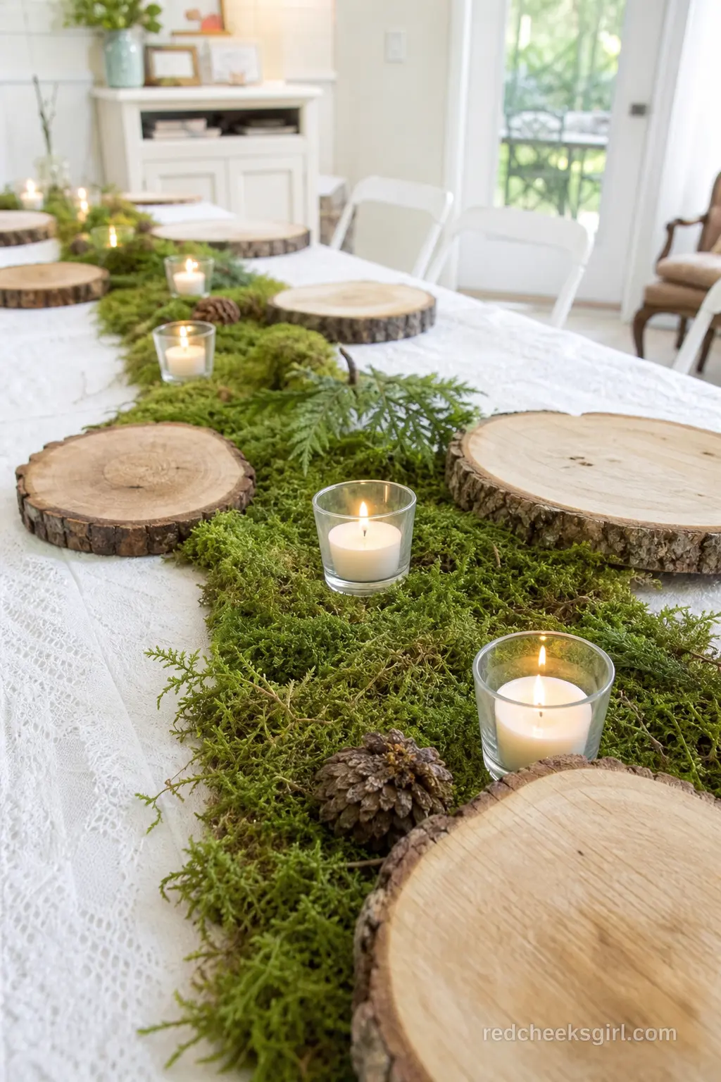A Wood Slice and Moss Runner Down the Middle — Wood slices laid end to end down the table, with a thin strip of preserved moss running through the centre and