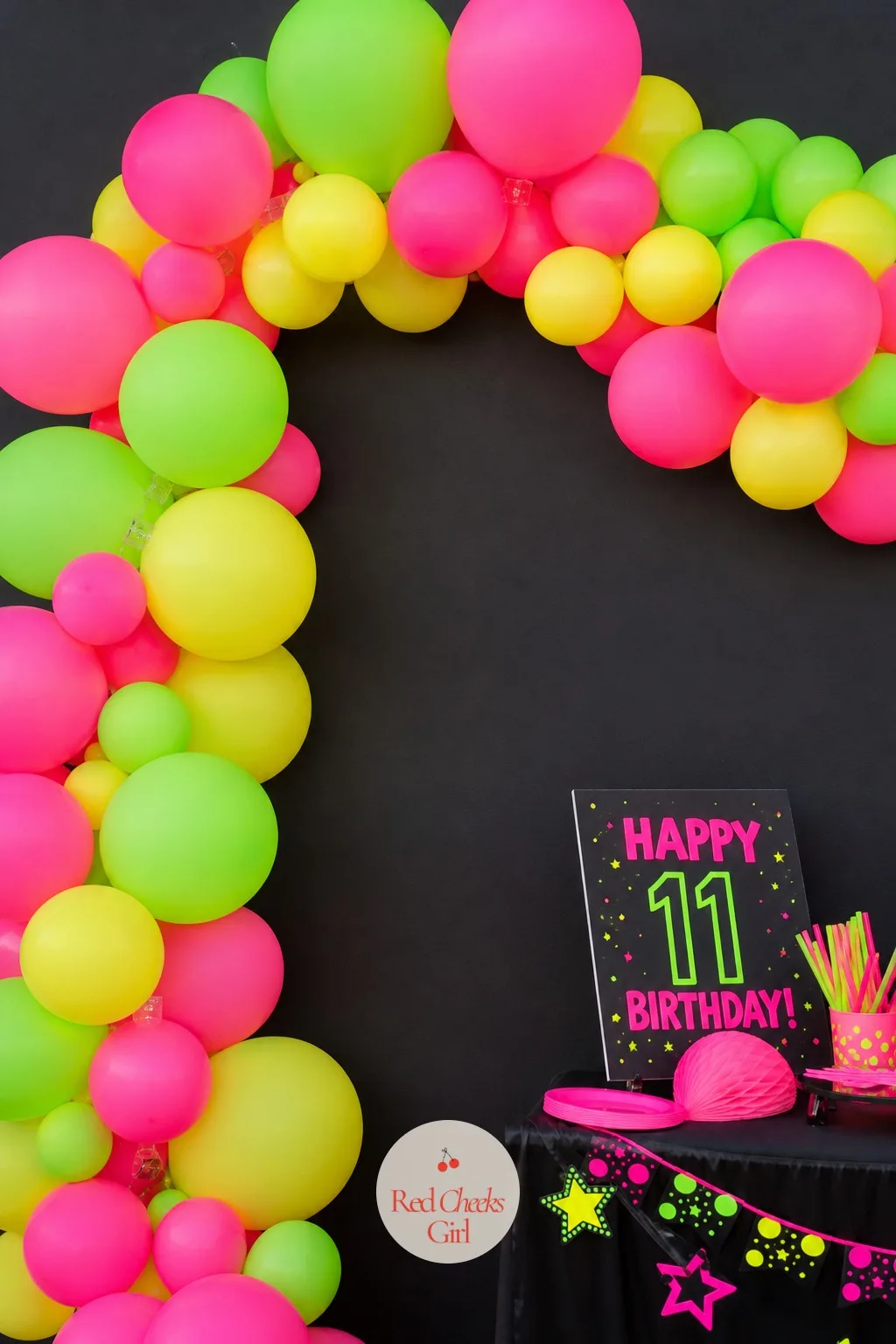 A Neon Balloon Arch Against a Black Wall — An arch gives the entry a reason to stop and look instead of walking straight past. 11th birthday party ideas
