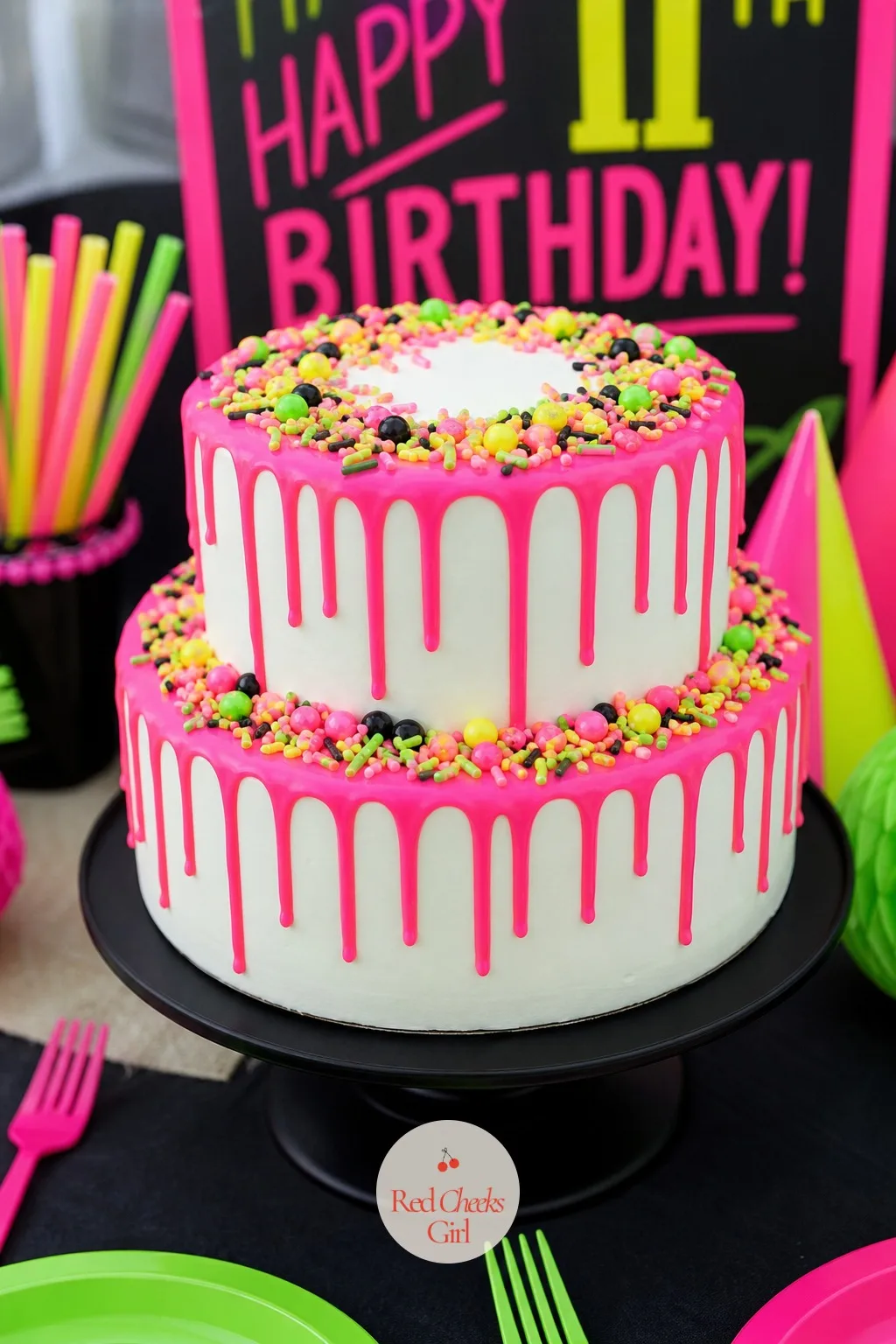 A Neon Drip Birthday Cake — A plain white cake is the right move here, because white frosting is one of the few party foods that actually glows under a black