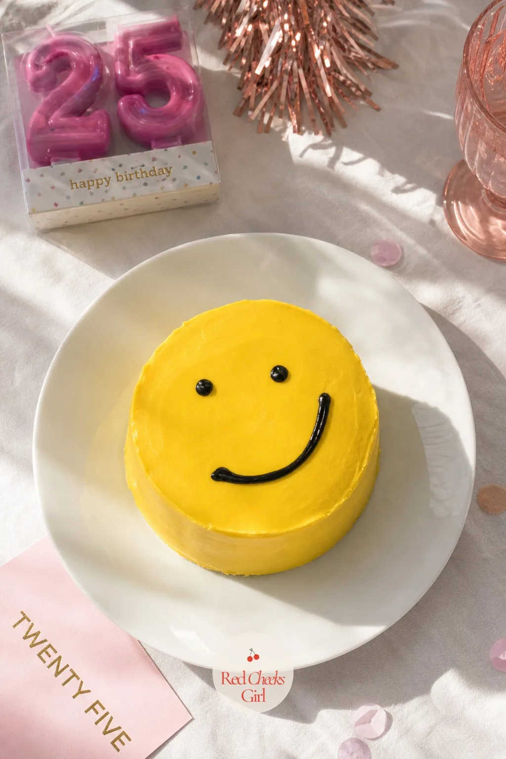 Smiley Face Bento Cake — Sunshine yellow icing, two black dot eyes and a crooked black smile piped straight onto the top: a cake that looks like it is in on
