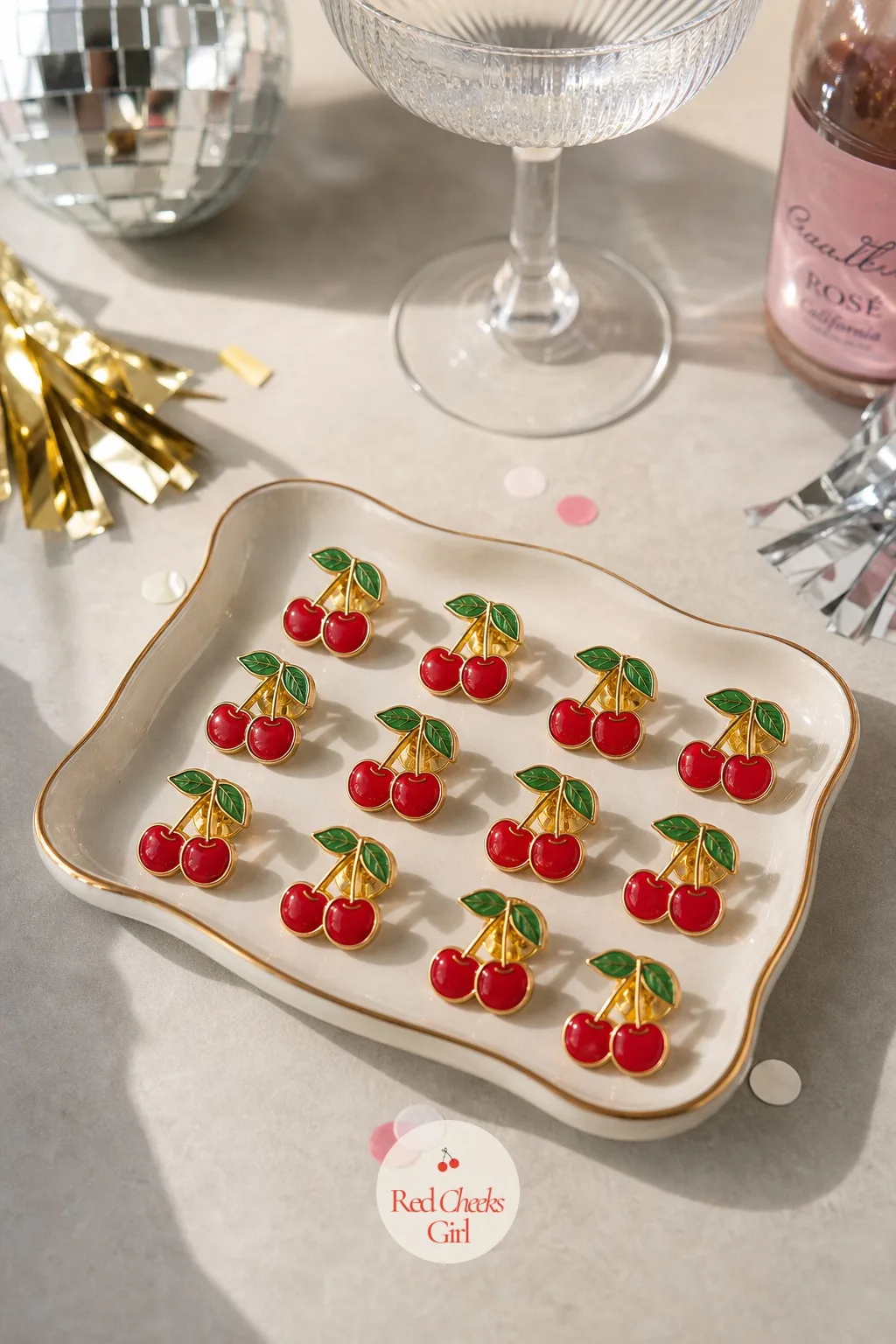 Enamel Cherry Pin Badges — The cherries from the cake earlier do not have to disappear once the plates are cleared; a small pin keeps the joke going long after