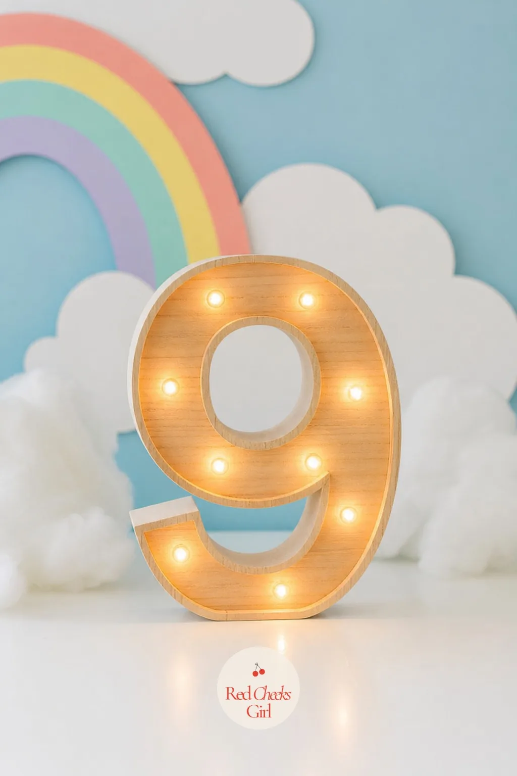 A Cloud Nine Marquee Sign — Wooden or acrylic letters spelling out the number nine or the words Cloud Nine, strung through with warm fairy lights rather than