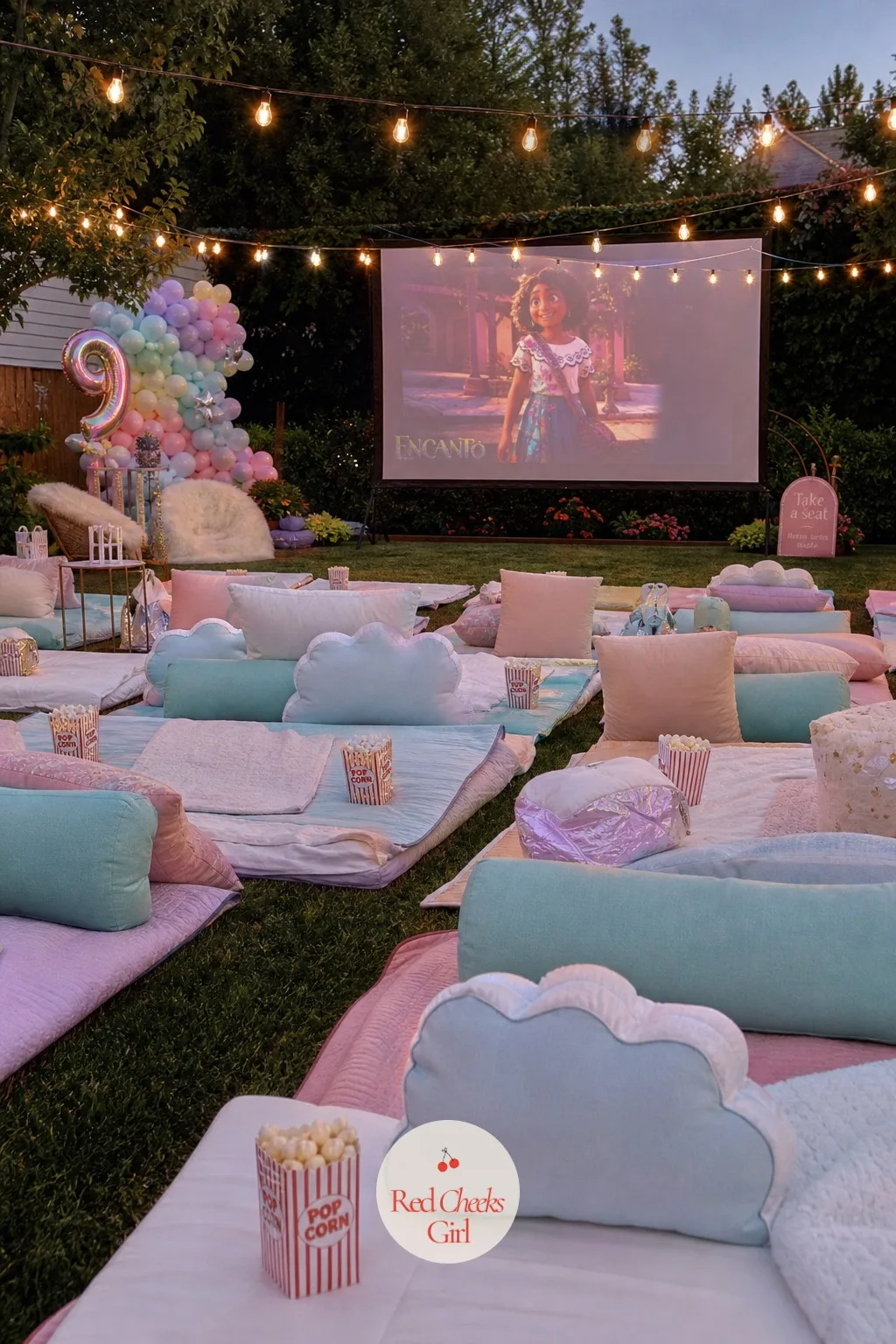 A Drive-In Movie Night — A flat sheet or portable projector screen hangs as the backdrop, with the projector itself set on a table behind the seating. 9th