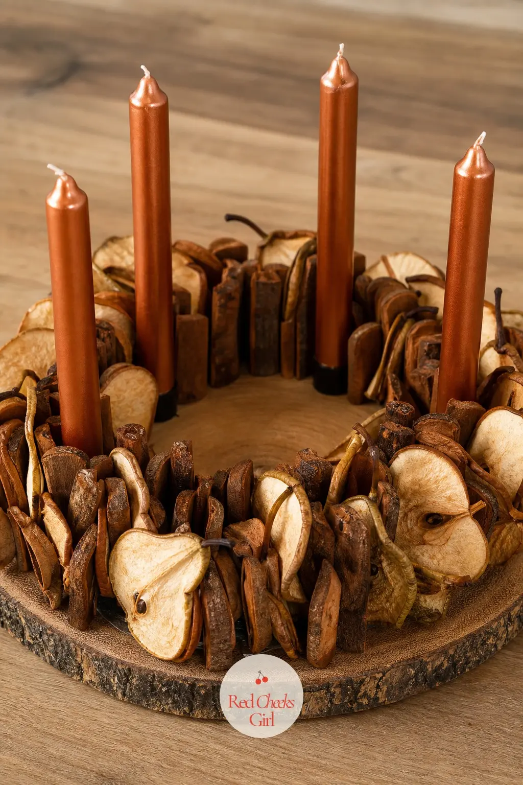Cinnamon Bark Coin Ring With Dried Pear Slices and Warm Copper Candles — Thin round coins of cinnamon bark, not the usual bundled sticks, sit flat around a