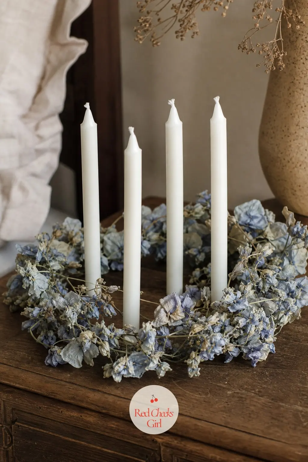 Four Slim Candles in a Trailing Sweet Pea Vine Ring for the Nightstand — A dusty blue dried sweet pea vine, trailing slightly over the edge rather than sitting