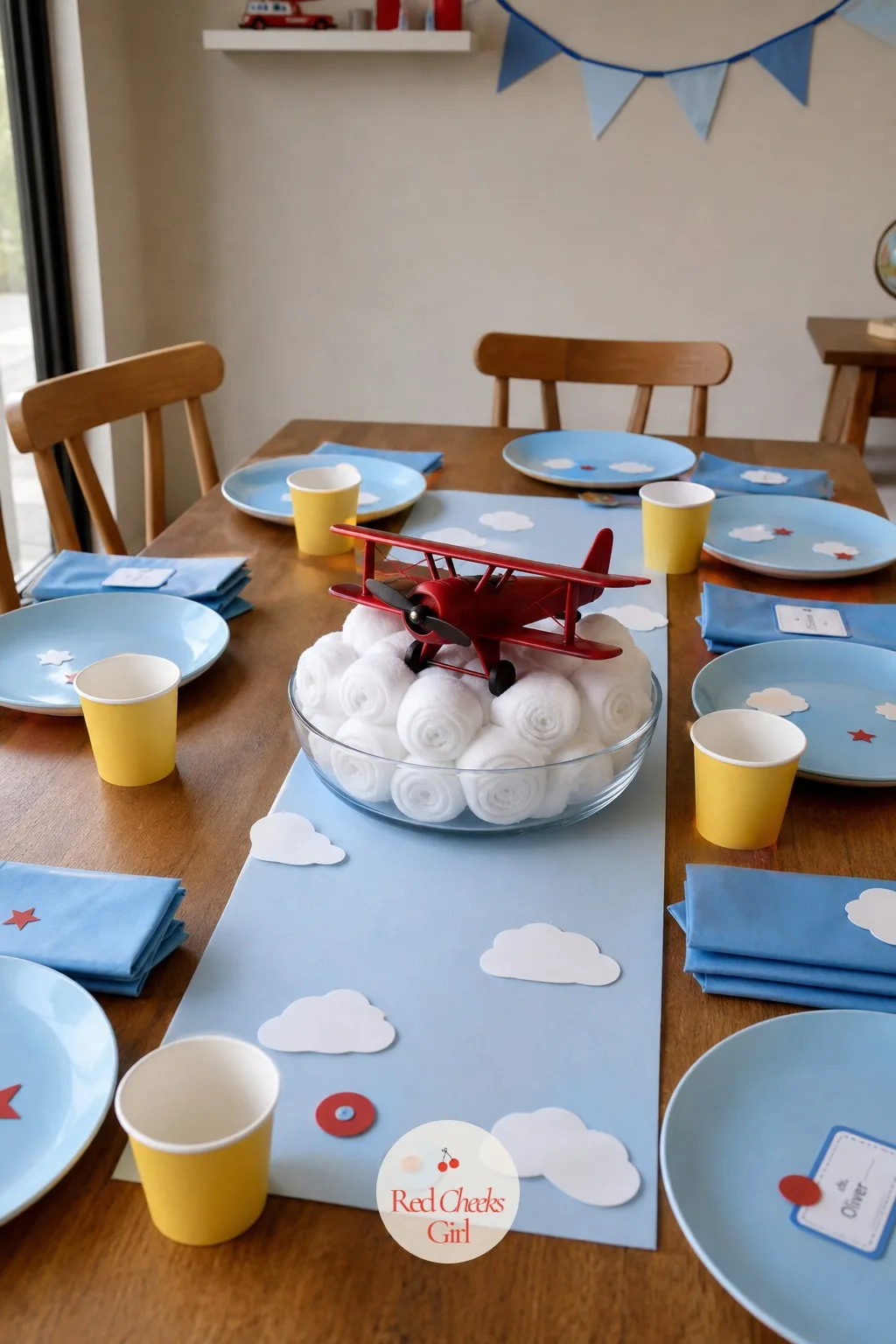 Toy Plane and Puffy Cloud Centerpiece — The table needs one low, calm thing at its centre, something that will not block a two year old's view of the person