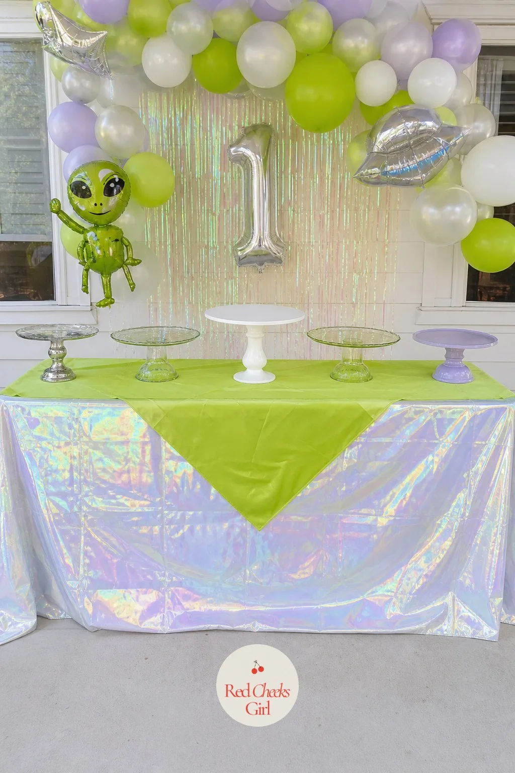 Dessert Table With Holographic Tablecloth — A folding table under a plain cloth looks exactly like what it is: a folding table. Alien first birthday party