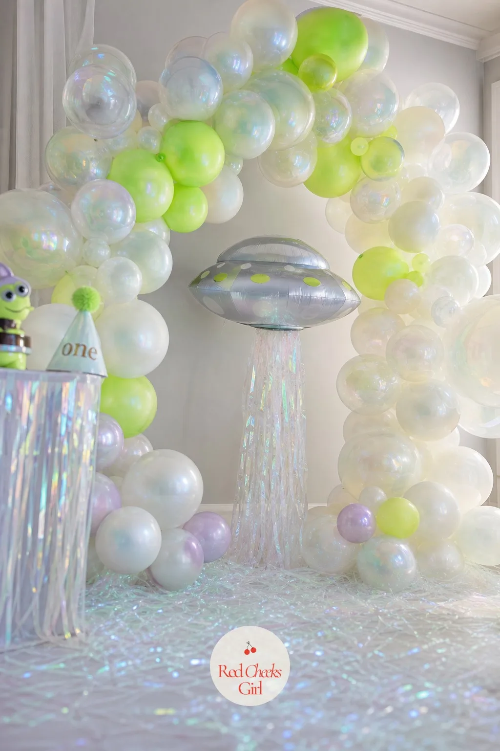 Flying Saucer Balloon Arch Backdrop — A blank wall behind the cake table always looks like an afterthought, no matter how nice the food is. Alien first