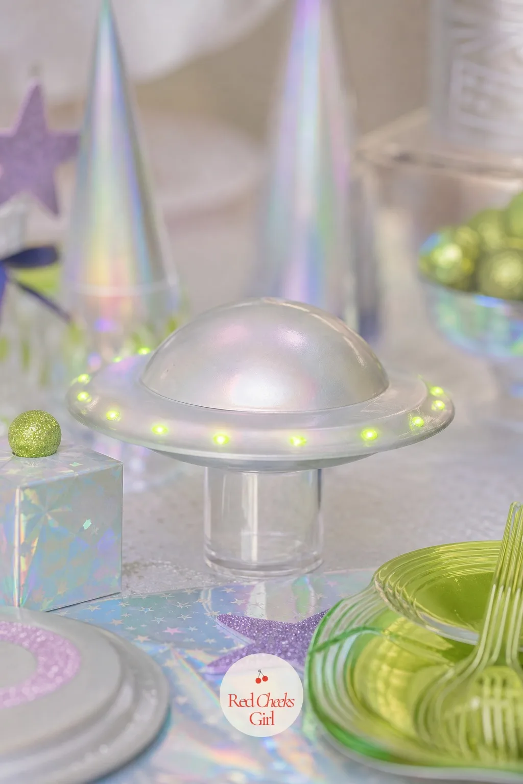 Flying Saucer Centerpieces — A dessert table laid out flat, everything the same height, photographs as a buffet rather than a party. Alien first birthday party