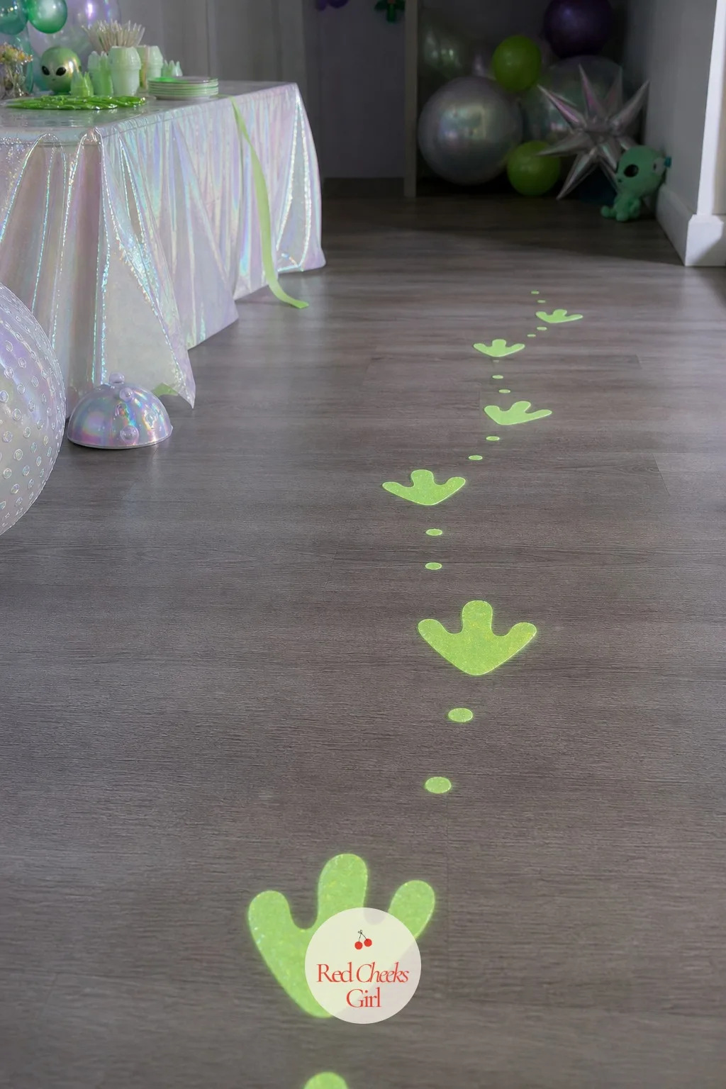 Glowing Alien Footprint Floor Trail — Guests walk in and stand around near the door, not quite sure which way the party actually is. Alien first birthday party