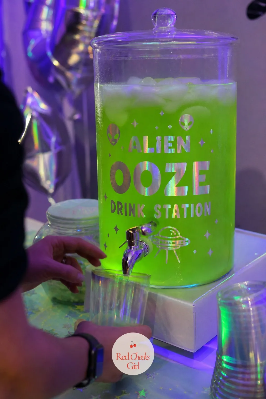 Glowing Alien Ooze Drink Station — A pitcher of plain lemonade sitting next to a themed table looks like it belongs to a different event entirely. Alien first