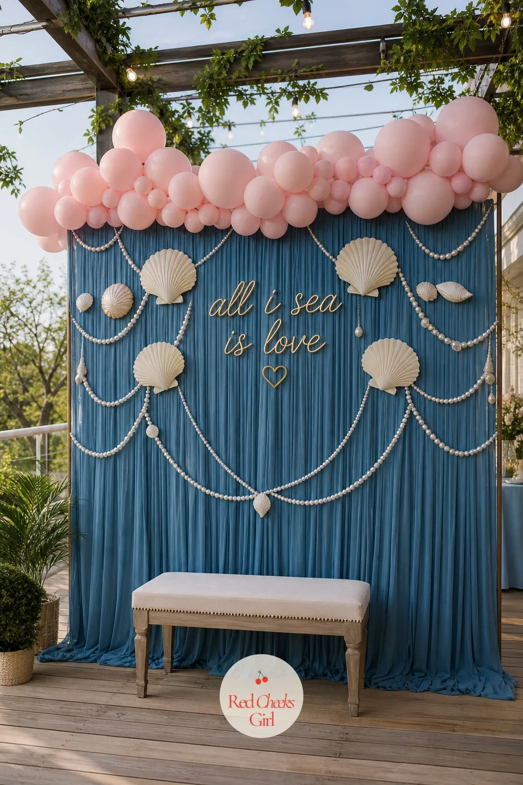 An Ocean Blue Photo Backdrop With Shells — Guests will find the corner with the best light within five minutes of arriving, so give them one worth finding. All