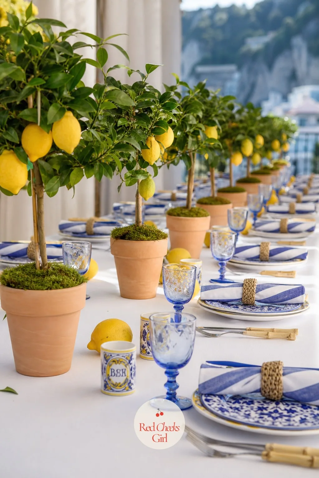 Lemon Tree Centerpieces Down the Table — A single big arrangement in the middle blocks conversation across the table. Amalfi coast baby shower theme